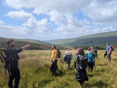 A group of Peatland Practitioner participants on open hillside