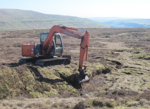 Image of peat slope reprofiling in progress © Tessa Levens